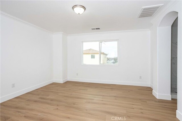 unfurnished room with light hardwood / wood-style flooring and ornamental molding