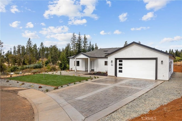 view of front of property featuring a garage and a front lawn