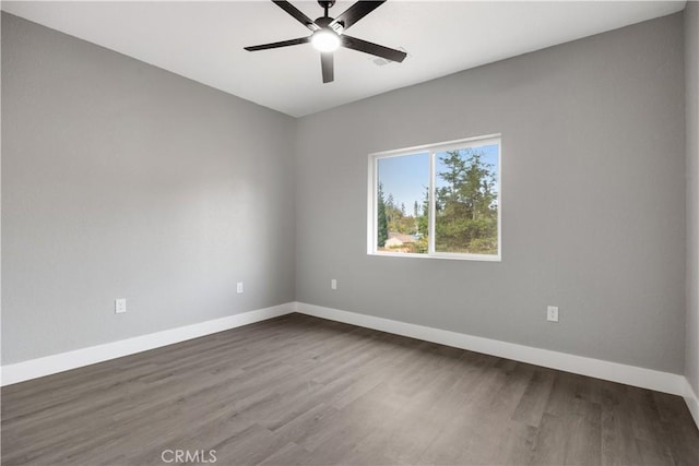 spare room featuring hardwood / wood-style floors and ceiling fan