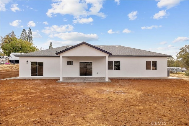 back of property with a patio