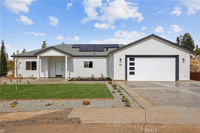 single story home featuring a garage, solar panels, and a front lawn