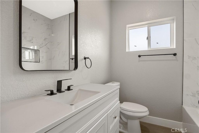 bathroom with vanity, wood-type flooring, and toilet