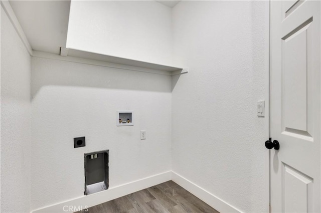 clothes washing area featuring washer hookup, hardwood / wood-style flooring, and hookup for an electric dryer