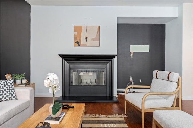 living area with hardwood / wood-style flooring