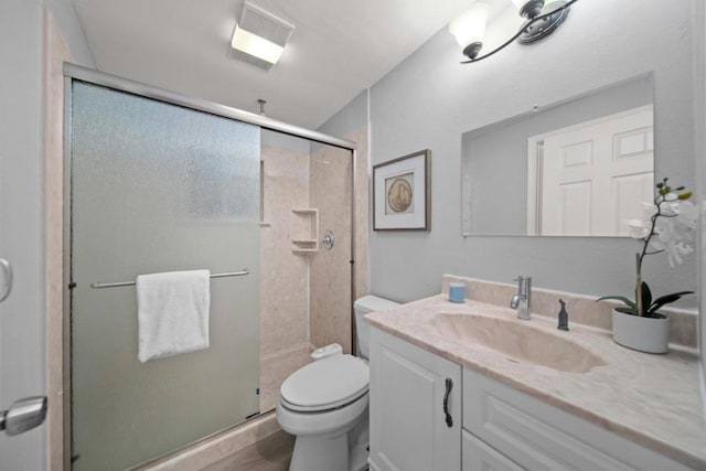 bathroom with vanity, walk in shower, and toilet