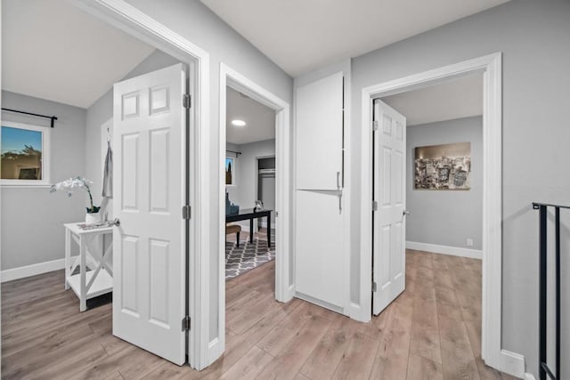 hall with light hardwood / wood-style floors