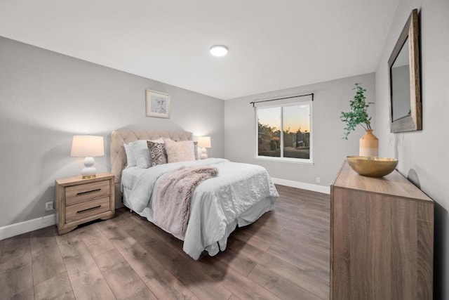 bedroom with dark wood-type flooring