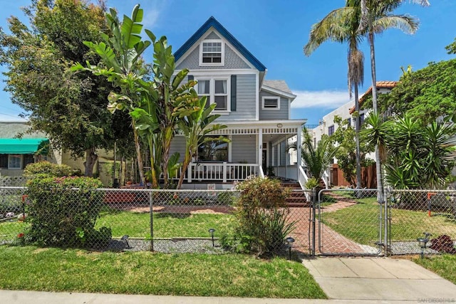 victorian home featuring covered porch and a front lawn