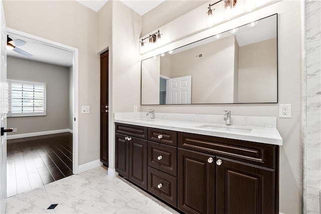 bathroom with ceiling fan and vanity