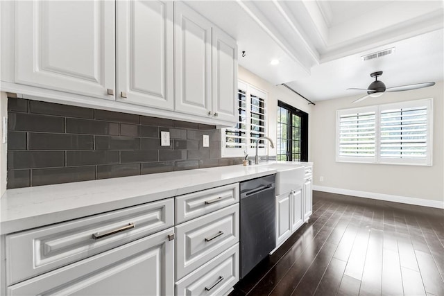 kitchen featuring tasteful backsplash, dishwasher, sink, crown molding, and white cabinetry