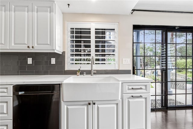 kitchen with dishwasher, white cabinets, backsplash, and sink