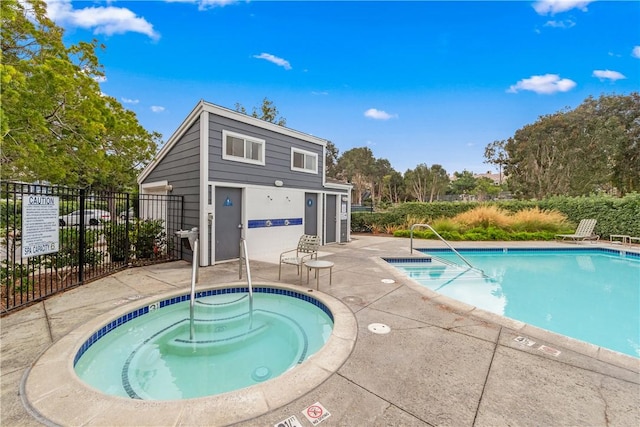 view of pool featuring a community hot tub and a patio