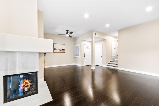 unfurnished living room with ceiling fan and dark hardwood / wood-style floors