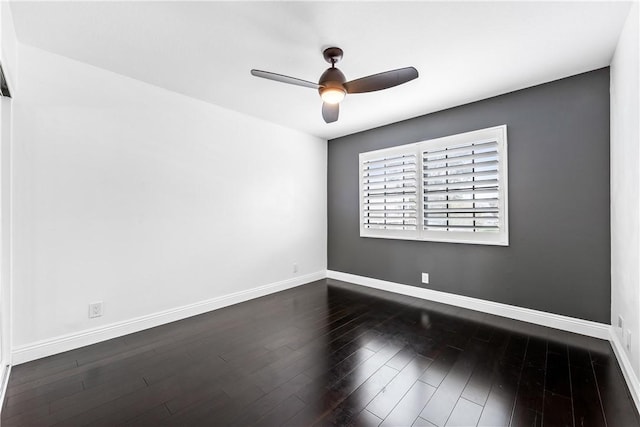 spare room featuring ceiling fan and dark wood-type flooring