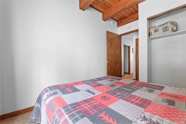 carpeted bedroom with wooden ceiling, a closet, and vaulted ceiling with beams