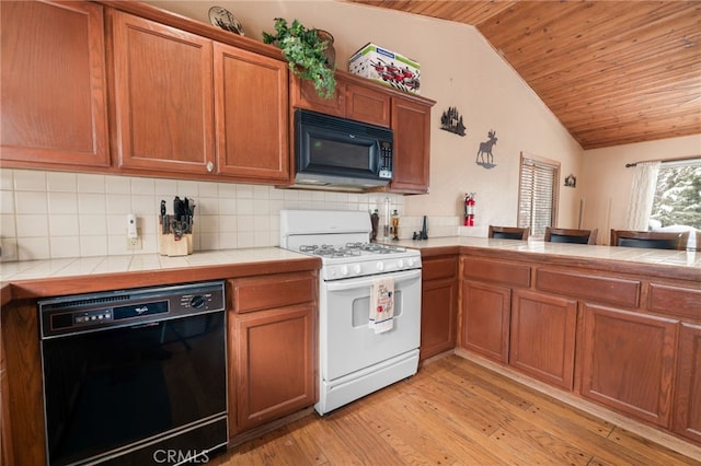 kitchen with wood ceiling, black appliances, tile countertops, and tasteful backsplash