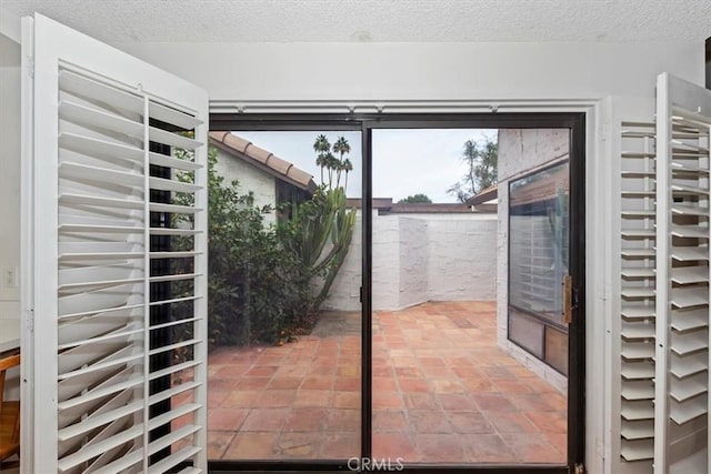 doorway featuring a textured ceiling