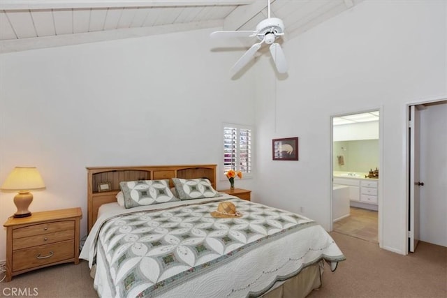 bedroom with connected bathroom, light carpet, high vaulted ceiling, ceiling fan, and beam ceiling