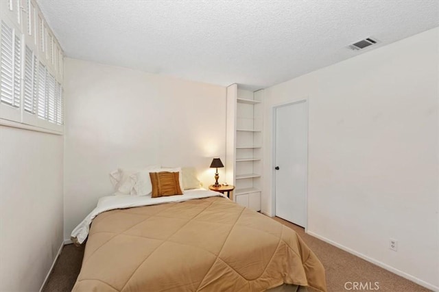 unfurnished bedroom featuring a textured ceiling and carpet flooring