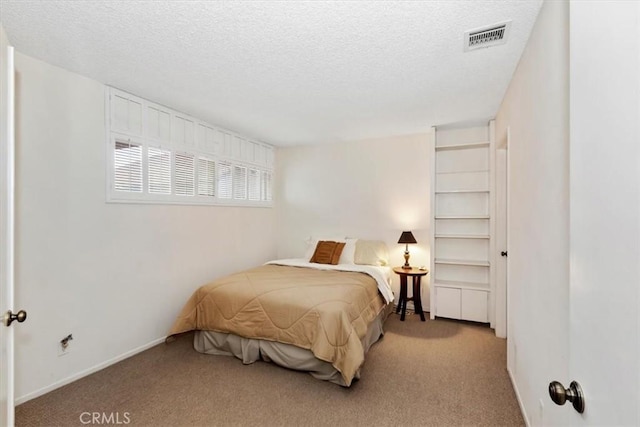 bedroom with light carpet and a textured ceiling