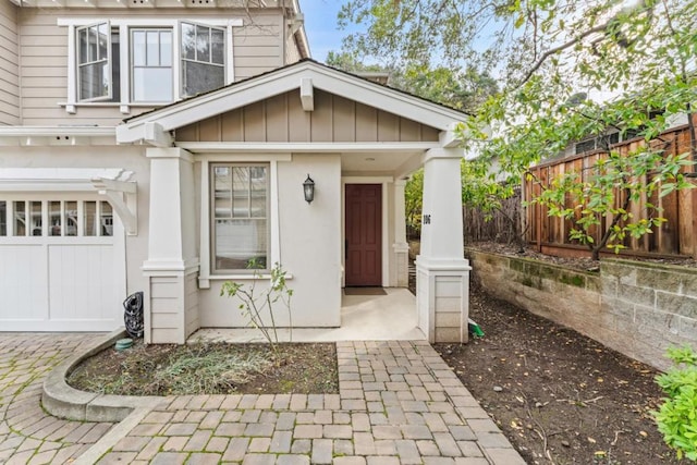 view of exterior entry featuring a garage