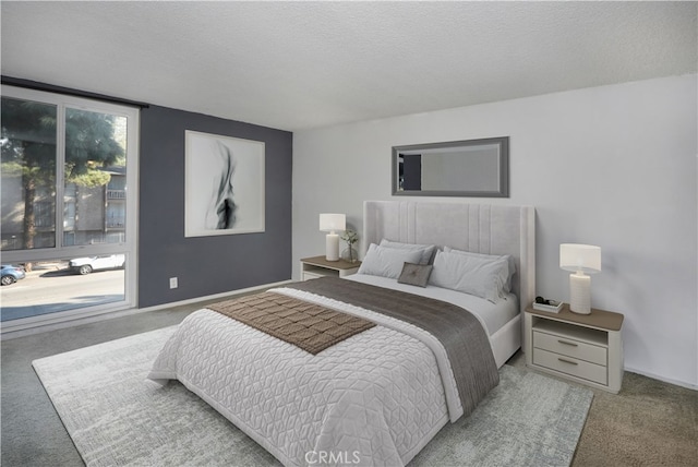 bedroom featuring a textured ceiling and carpet floors