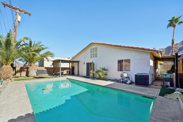 view of swimming pool featuring central air condition unit and a patio