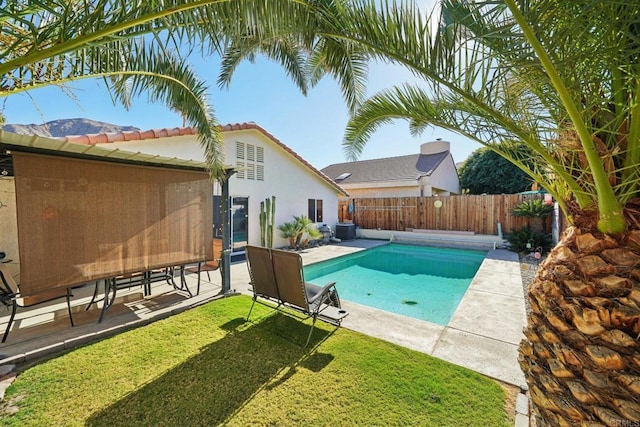 view of swimming pool featuring a patio area and a lawn