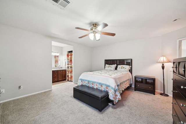 carpeted bedroom featuring ceiling fan and ensuite bathroom