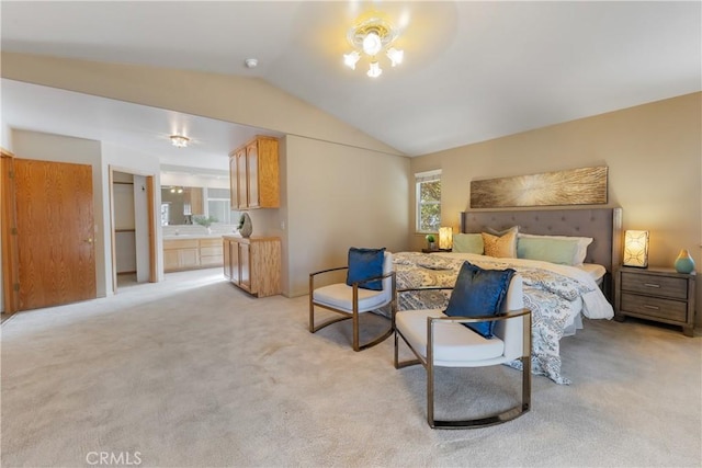 carpeted bedroom with lofted ceiling and connected bathroom