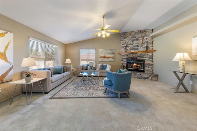 carpeted living room featuring ceiling fan, lofted ceiling, and a stone fireplace