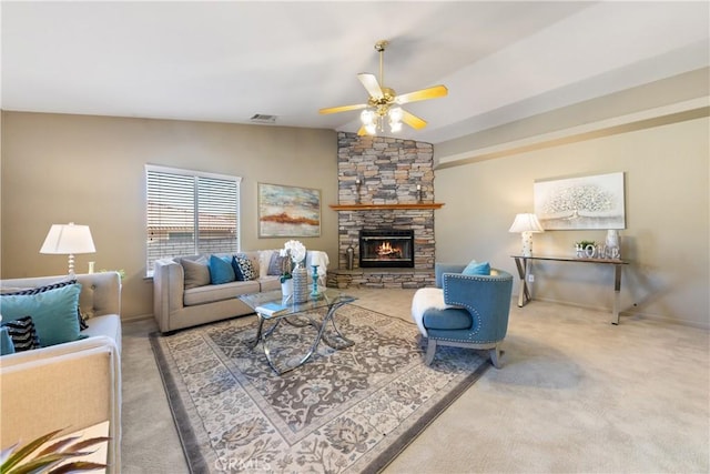 living room with ceiling fan, carpet, vaulted ceiling, and a fireplace