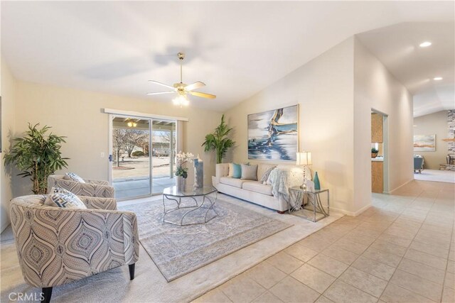 tiled living room with ceiling fan and lofted ceiling