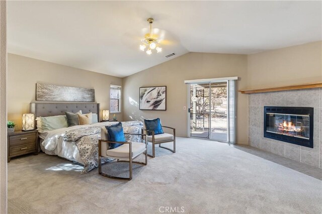 carpeted bedroom with ceiling fan, access to exterior, a fireplace, and lofted ceiling