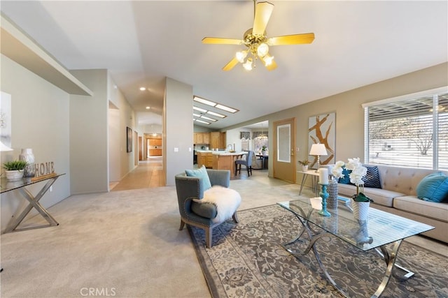 carpeted living room with ceiling fan and lofted ceiling