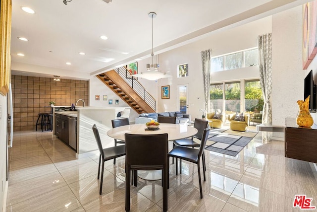 dining room with a towering ceiling