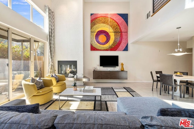 tiled living room featuring a high ceiling