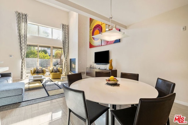 dining room with a towering ceiling