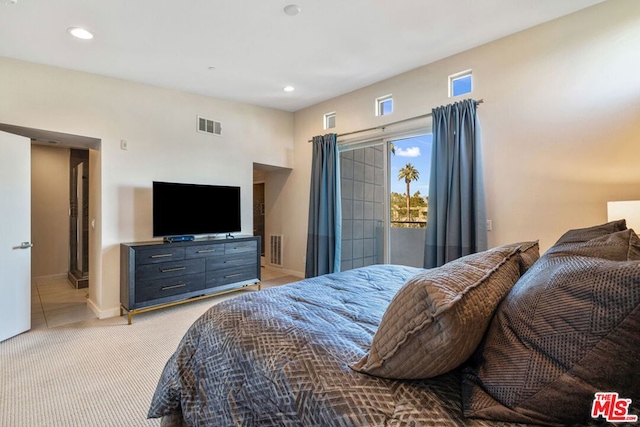 bedroom with light colored carpet and access to outside