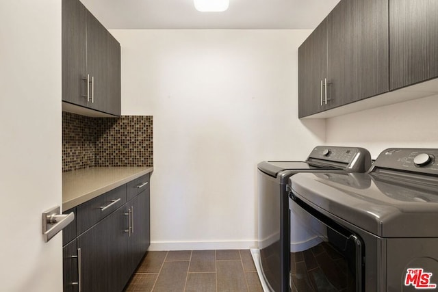 washroom with cabinets and washer and clothes dryer