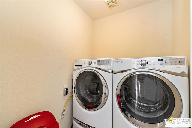 clothes washing area with independent washer and dryer