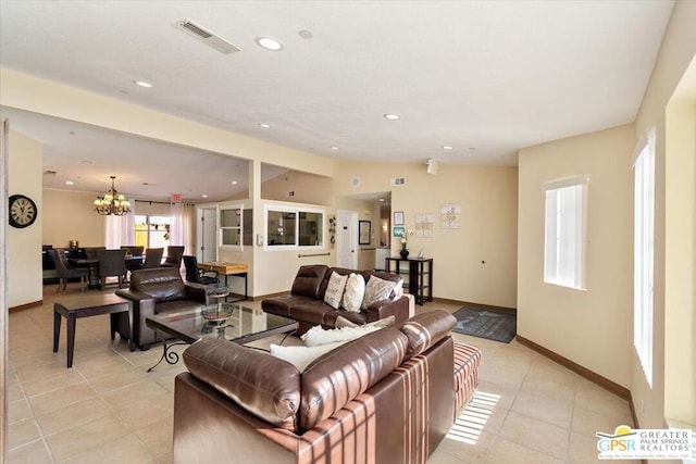 tiled living room featuring a notable chandelier