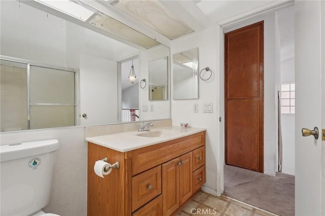 bathroom with vanity, an enclosed shower, and toilet