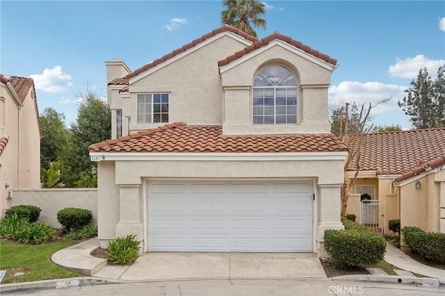 mediterranean / spanish-style house with a garage