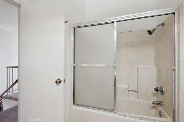 bathroom featuring combined bath / shower with glass door