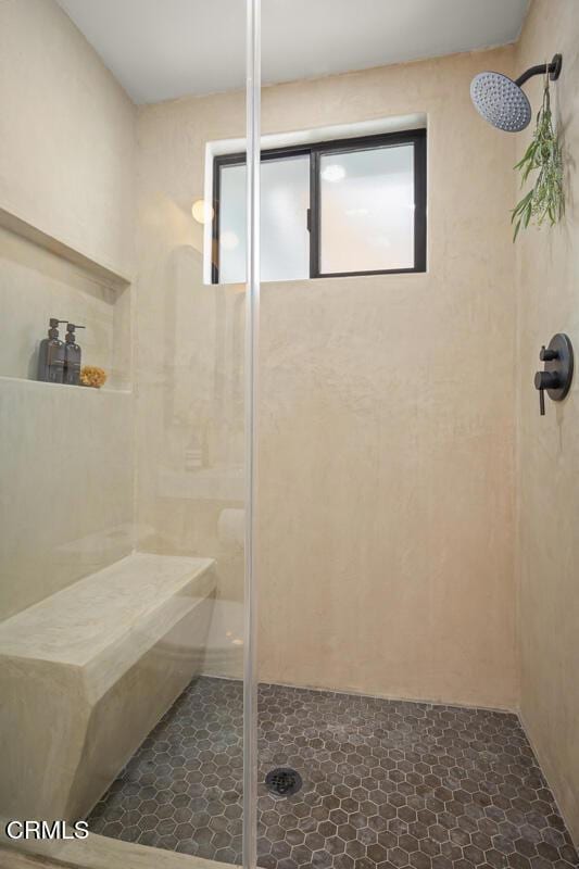 bathroom featuring a shower with shower door