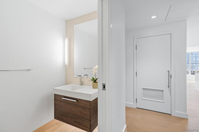 bathroom with vanity and hardwood / wood-style flooring