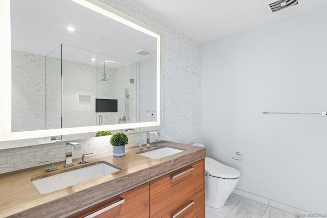 bathroom with an enclosed shower, vanity, backsplash, and toilet