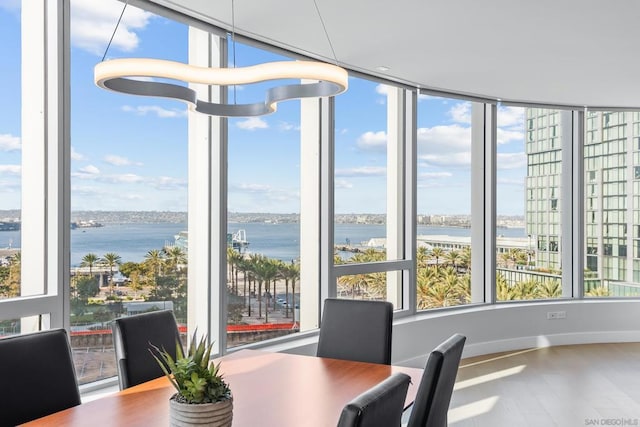 sunroom featuring a water view