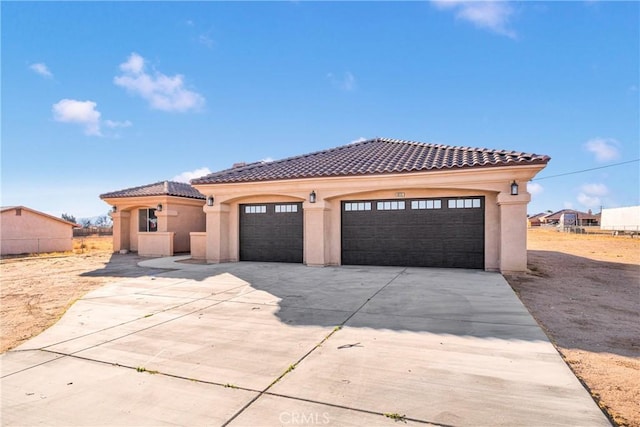 mediterranean / spanish home featuring a garage